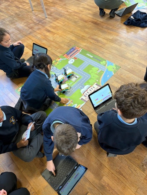children sitting around mat