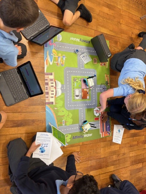 children sitting around mat
